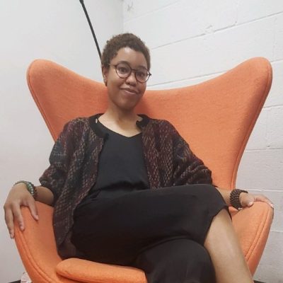 mya with the orange chair
